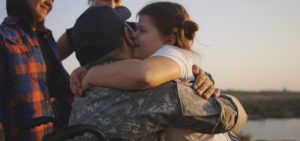 child hugging her disabled veteran relative